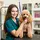 happy customer with her groomed poodle in a bright well lit pet boutique