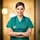 veterinary professional in green scrubs background out of focus with warm lighting